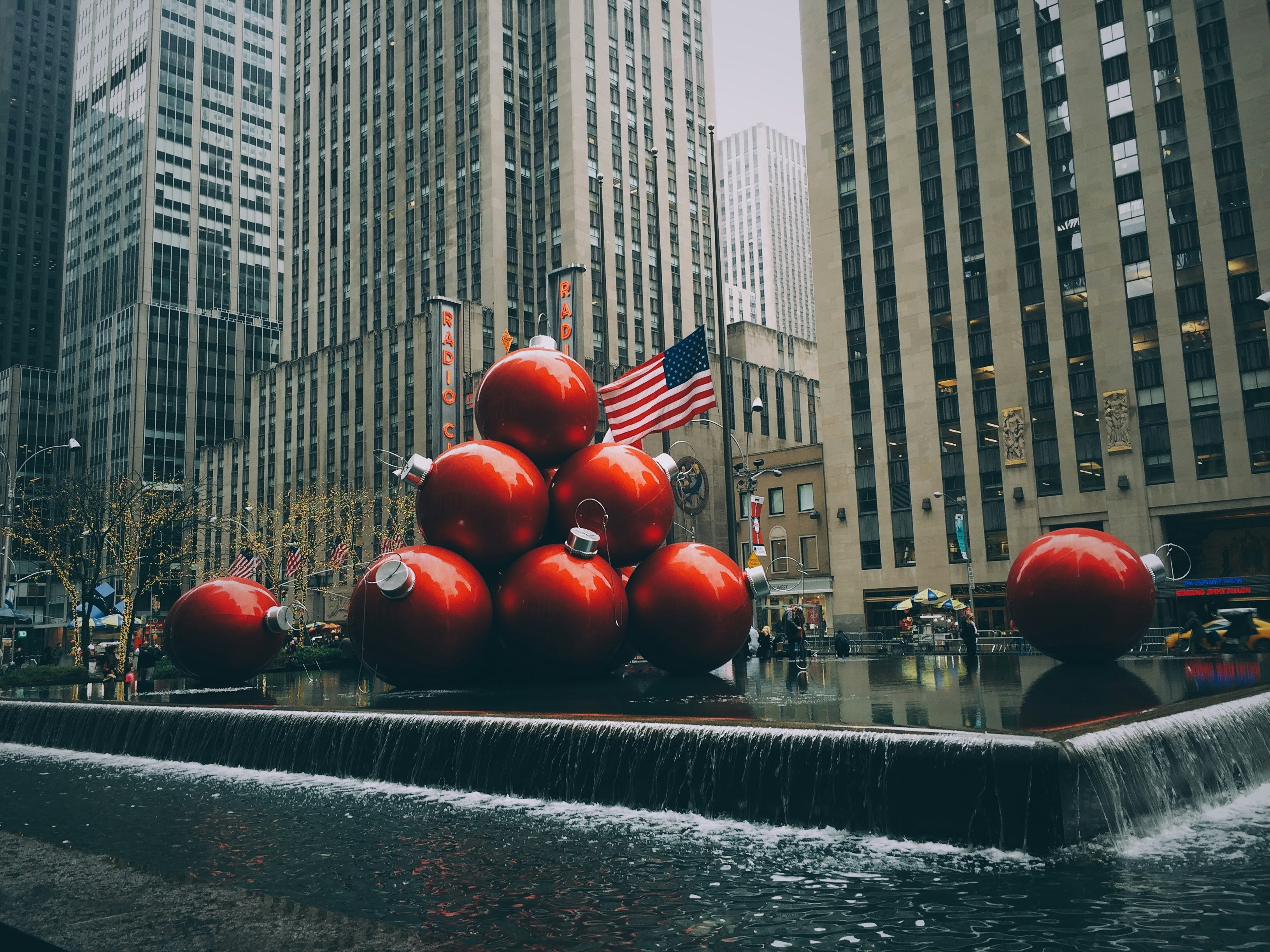 red bauble fountain near buildings